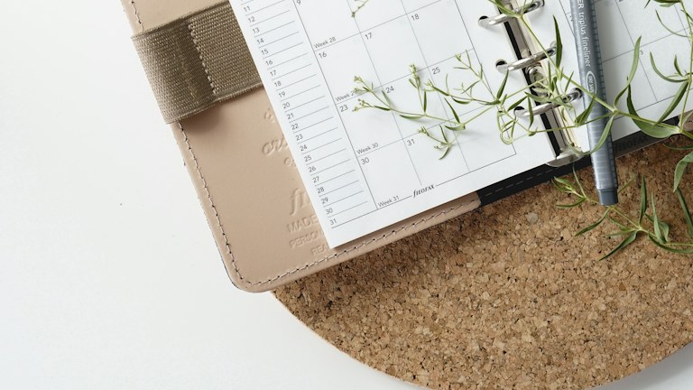 grey and black pen on calendar book
