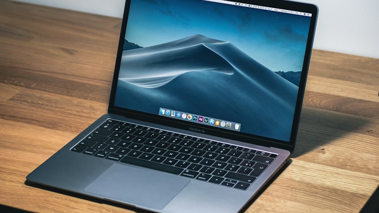 open macbook air on wooden desk