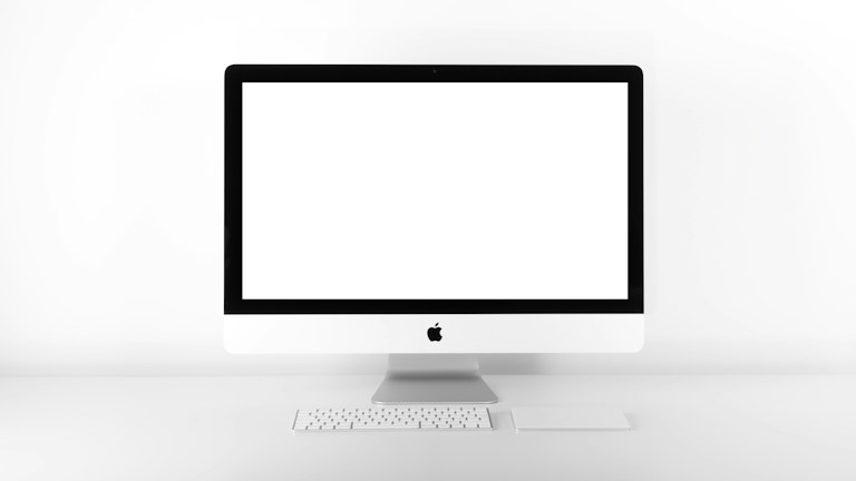 silver iMac with Apple Magic Keyboard on white sufrace
