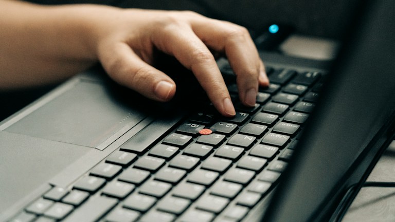 person using black and gray laptop computer